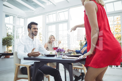 Aggressive woman throwing wine on man face