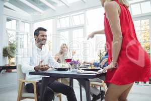 Aggressive woman throwing wine on man face