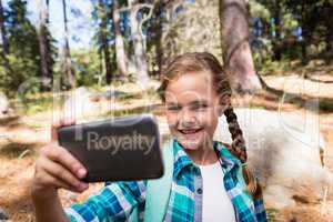 Girl taking a selfie in the forest