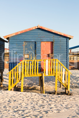 Multi colored beach hut on sand