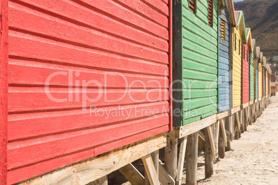 Crooped image of wooden huts on sand