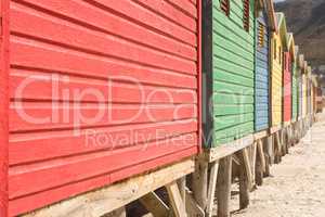 Crooped image of wooden huts on sand