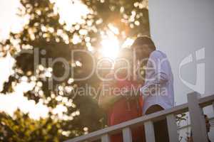 Affectionate couple having champagne in balcony