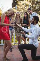 Man proposing woman in balcony