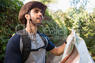 Man holding the map and looking at the distance