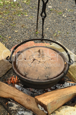 Preparing the goulash in a cettle with clay cover