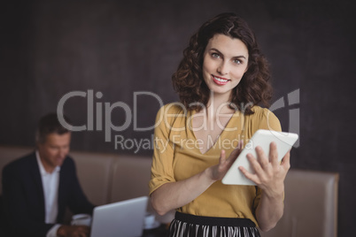 Woman using digital tablet in restaurant