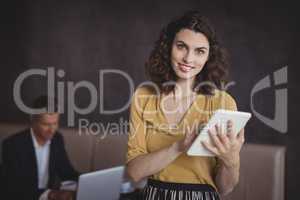 Woman using digital tablet in restaurant