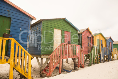 Wooden colorful huts on sand