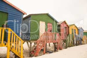 Wooden colorful huts on sand