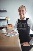 Smiling waitress at counter