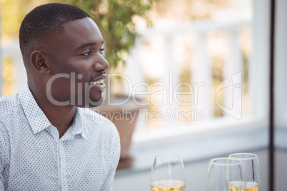 Smiling man having wine during lunch