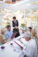 Friends placing order to waiter