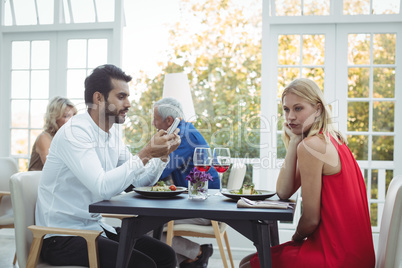 Man ignoring bored woman