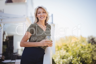 Portrait of mature woman holding a glass of juice