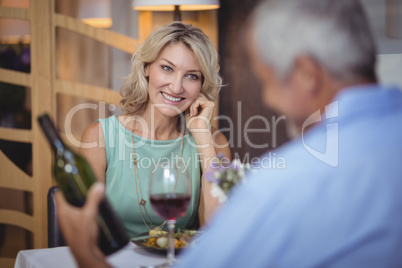 Mature couple having meal and red wine