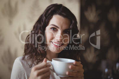 Portrait of young woman having coffee