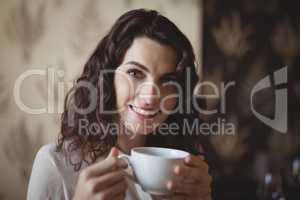 Portrait of young woman having coffee