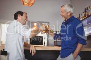 Two men toasting their beer glasses