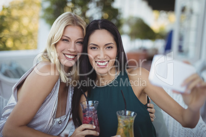 Womens taking selfie on mobile phone