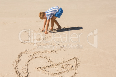 Side view of boy playing with sand