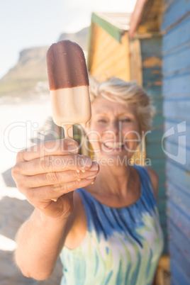 Happy senior woman holding ice cream