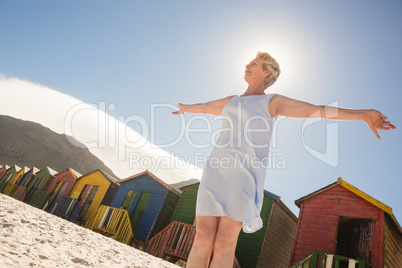 Low angle view of woman standing on sand against clear sky
