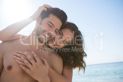 Smiling young couple embracing at beach