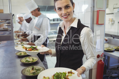 Waitress showing dishes to the camera