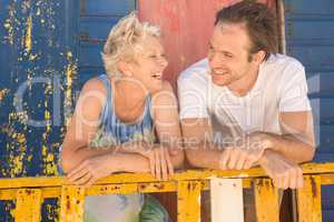 Happy mother and son leaning on railing