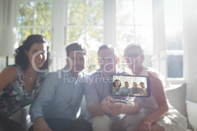Group of friends taking a selfie on mobile phone