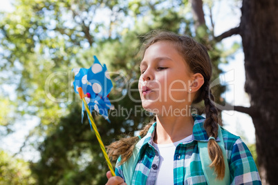 Close-up of girl blowing a pinwheel
