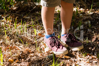 Boy in shoes standing in the forest