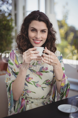 Portrait of beautiful woman having coffee