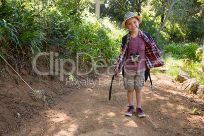 Smiling boy standing in the forest
