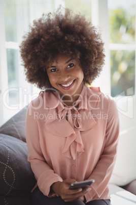 Portrait of happy woman using mobile phone