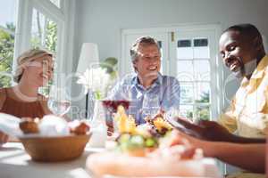 Group of friends interacting while having meal