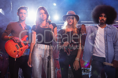 Portrait of young performers standing on stage at nightclub