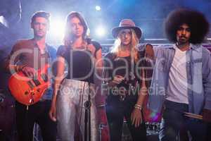 Portrait of young performers standing on stage at nightclub