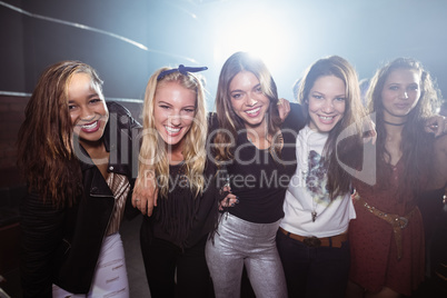 Portrait of happy female friends at nightclub