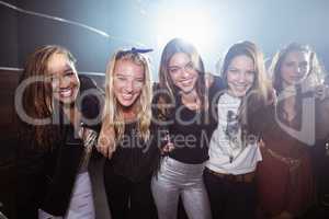 Portrait of happy female friends at nightclub