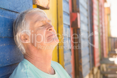 Close up of senior man relaxing by beach hut