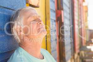Close up of senior man relaxing by beach hut
