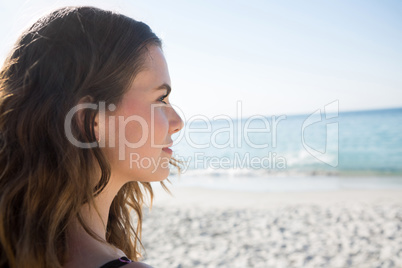 Thoughtful woman looking away at beach