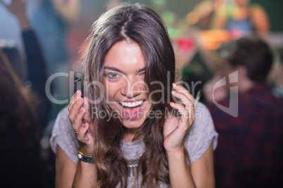 Close-up of woman with mouth open in nightclub