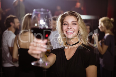 Portrait of smiling young woman holding wineglass