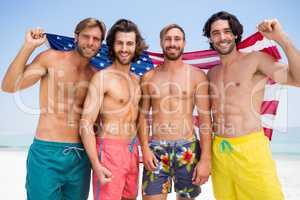 Portrait of male friends holding American flag