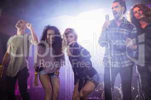 Portrait of female musicians with male performers at nightclub