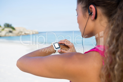 Woman using smart watch while jogging