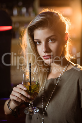 Portrait of young woman holding drink